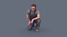 Foreman in Overalls Sitting on One Knee