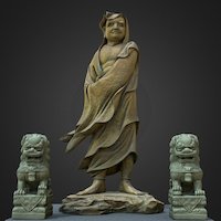 Daruma (Bodhidharma) with two guardian lions